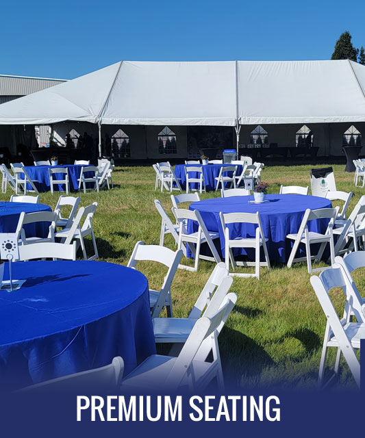 Premium Seating Options - Round Cloth-lined tables surrounded by folding white chairs.